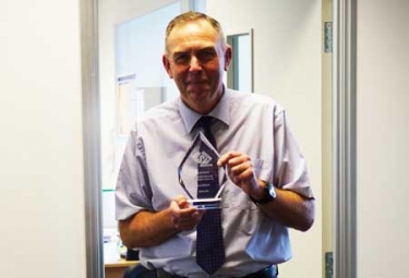 Gerry Green holding award