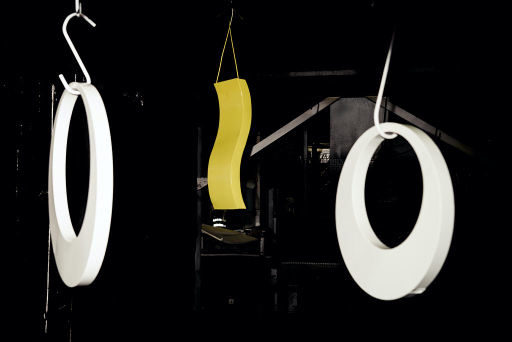 Powder coated steel fabrications hanging from hooks